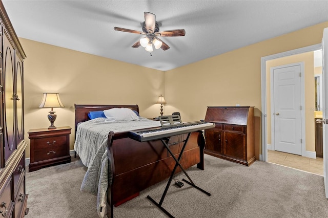 bedroom featuring ceiling fan and light carpet