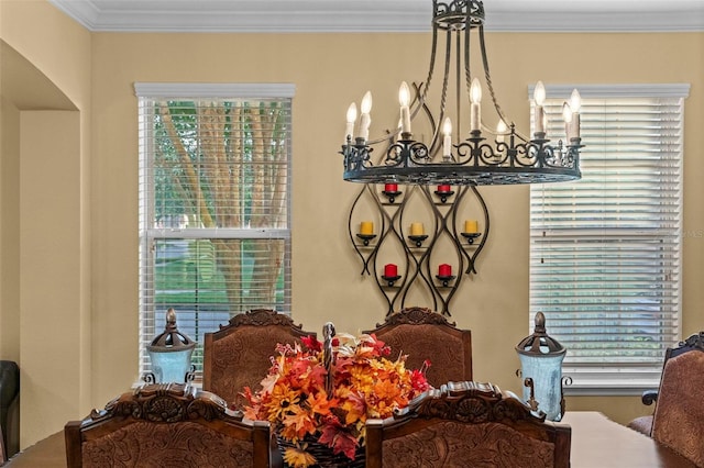 interior details with crown molding and a chandelier