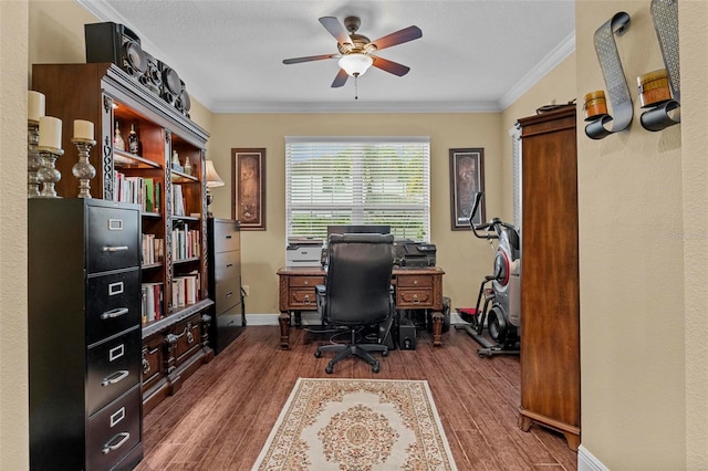 office space featuring ornamental molding, wood finished floors, a ceiling fan, and baseboards