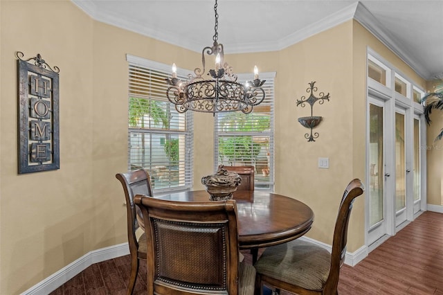 dining area featuring baseboards, crown molding, and wood finished floors