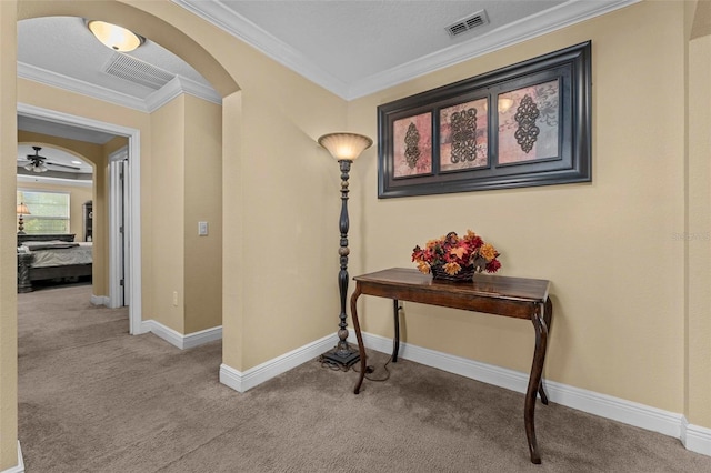 hall with carpet floors and ornamental molding