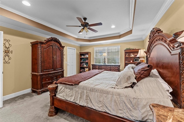 bedroom with a tray ceiling, carpet, crown molding, ceiling fan, and baseboards