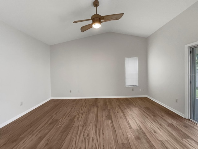 empty room with hardwood / wood-style flooring, ceiling fan, and lofted ceiling