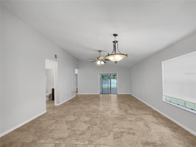 tiled empty room with ceiling fan