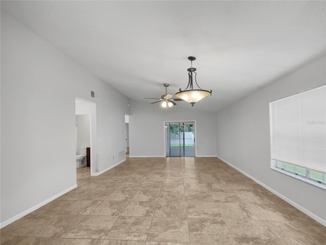 spare room featuring vaulted ceiling and ceiling fan