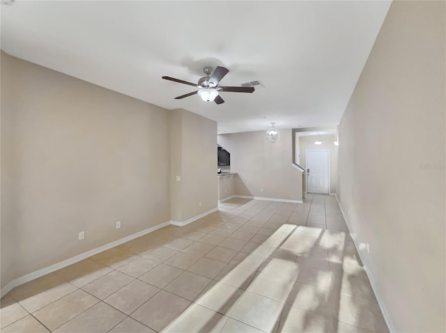 tiled spare room featuring ceiling fan