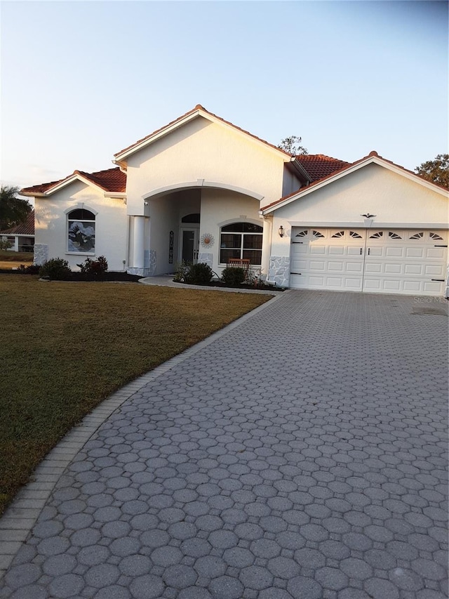 single story home with a front yard and a garage