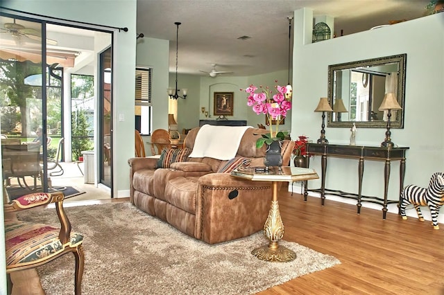 living room featuring hardwood / wood-style flooring and ceiling fan