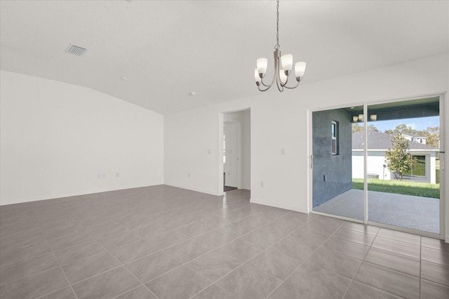 empty room featuring a chandelier and light tile patterned floors