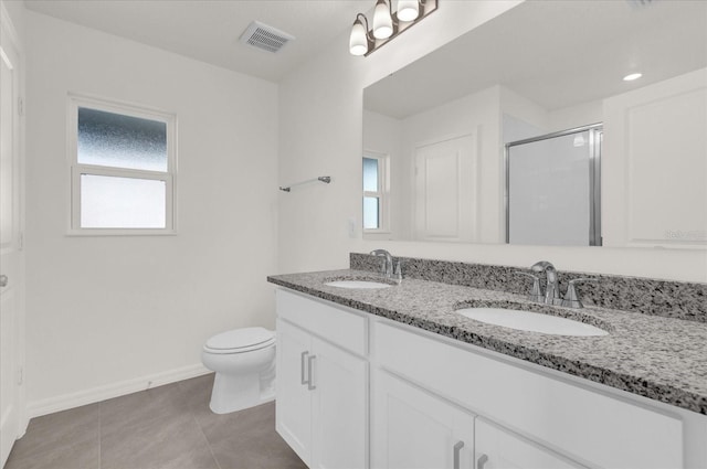 bathroom featuring a shower with door, vanity, toilet, and tile patterned flooring