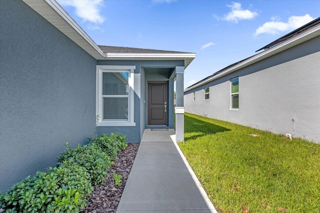 doorway to property with a yard