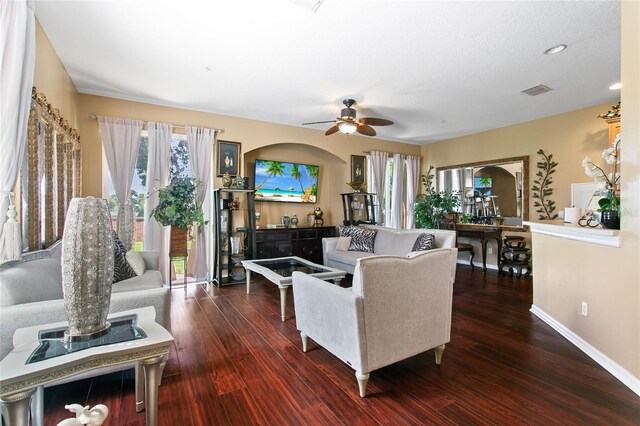 living room featuring ceiling fan and hardwood / wood-style floors