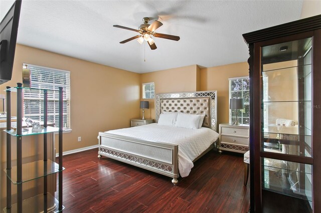 bedroom with dark wood-type flooring and multiple windows