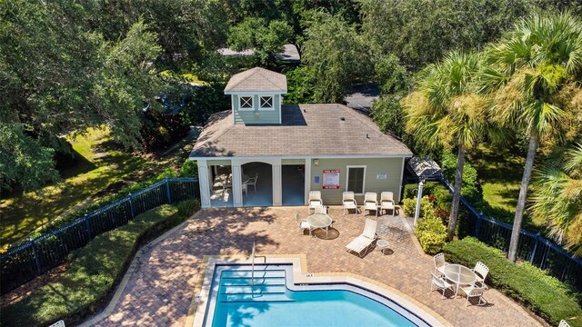 view of pool with an outdoor structure and a patio area