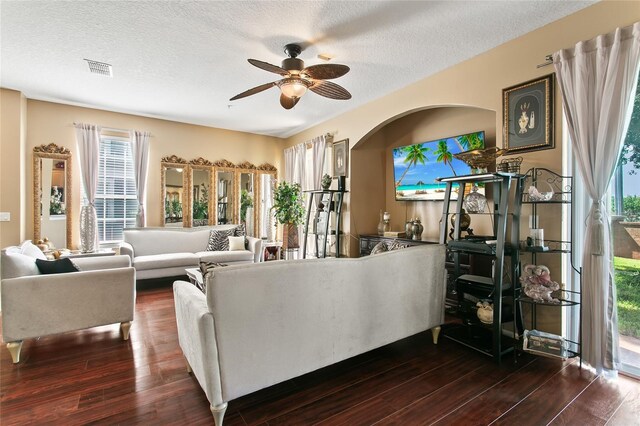 living room featuring hardwood / wood-style flooring, a textured ceiling, and ceiling fan