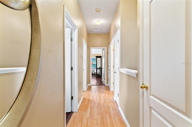 hall with light hardwood / wood-style floors