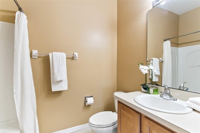 bathroom with tile patterned flooring, toilet, and vanity