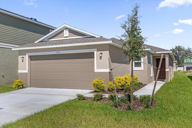 view of front of property featuring a front yard and a garage