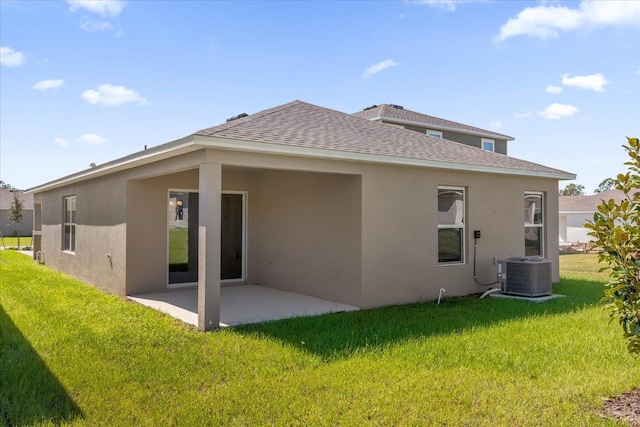 rear view of property featuring central AC, a yard, and a patio