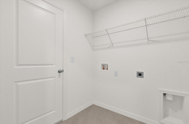 clothes washing area featuring hookup for a washing machine, light tile patterned floors, and electric dryer hookup