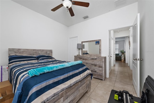 bedroom with ceiling fan and light tile patterned flooring