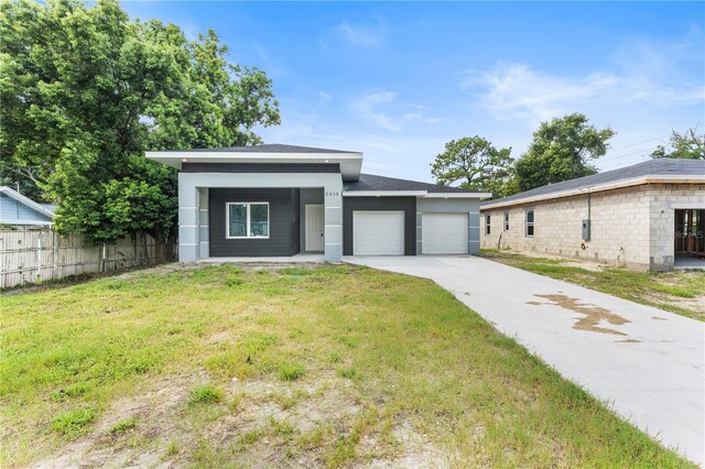 view of front facade with a garage and a front lawn