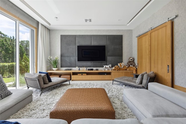 living room with a fireplace and plenty of natural light