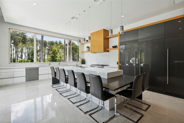 tiled dining room featuring sink