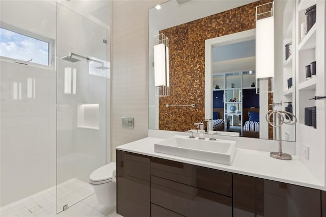 bathroom featuring tile patterned flooring, toilet, walk in shower, and vanity