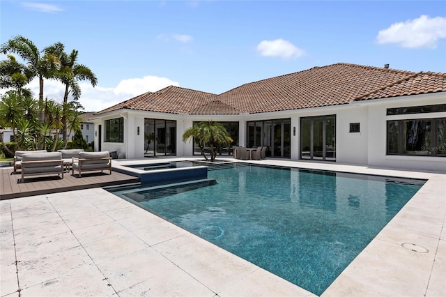 view of pool featuring an in ground hot tub and a patio area