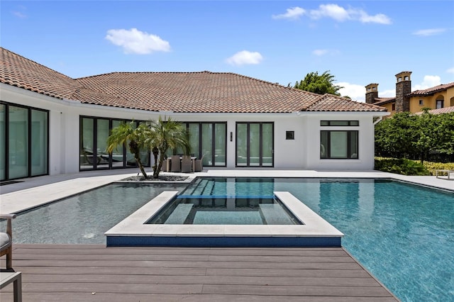 view of swimming pool featuring an in ground hot tub and a patio