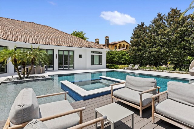 view of pool with an in ground hot tub and a patio