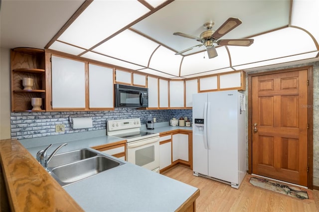 kitchen featuring white cabinetry, sink, white appliances, ceiling fan, and light hardwood / wood-style flooring