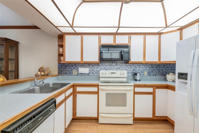 kitchen with backsplash, white appliances, light hardwood / wood-style floors, and white cabinets