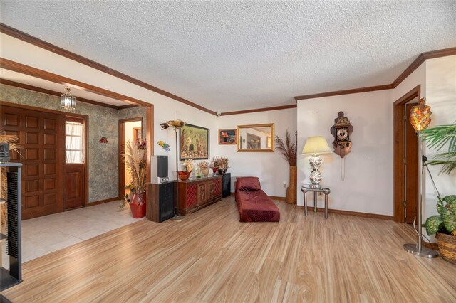 living area featuring light hardwood / wood-style floors, a textured ceiling, and crown molding