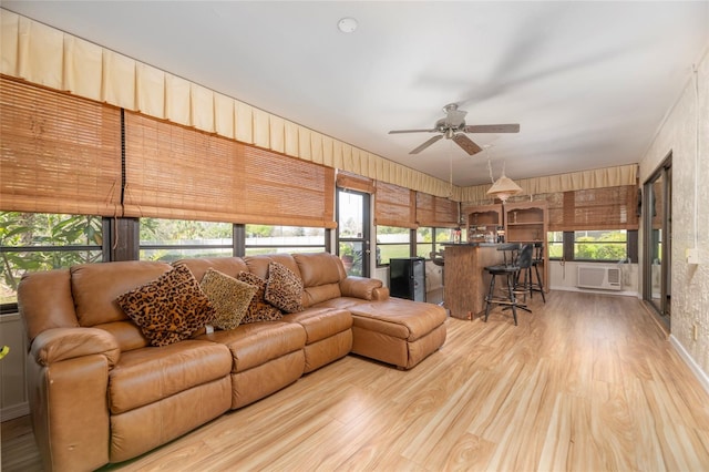 living room with ceiling fan, wood-type flooring, wood walls, and cooling unit