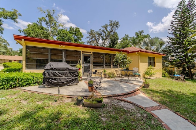 rear view of house with a yard and a patio area