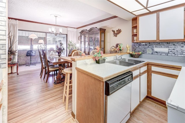 1546 Stormway Ct, Apopka, FL 32712 - kitchen with dishwasher, a sink, light countertops, tasteful backsplash, and a peninsula