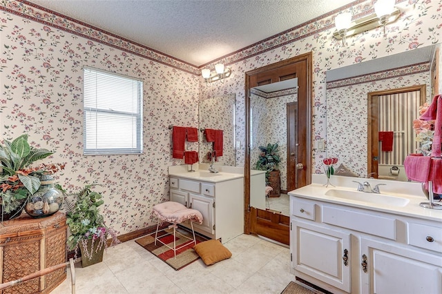 1546 Stormway Ct, Apopka, FL 32712 - bathroom featuring wallpapered walls, a textured ceiling, two vanities, and tile patterned floors