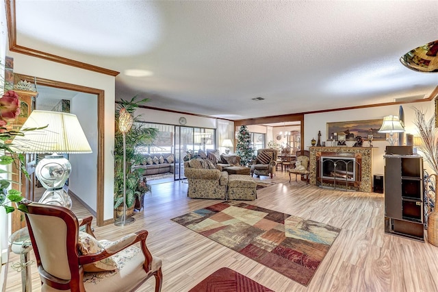 1546 Stormway Ct, Apopka, FL 32712 - living area featuring crown molding, a textured ceiling, wood finished floors, and a fireplace