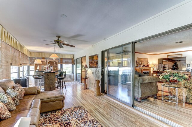1546 Stormway Ct, Apopka, FL 32712 - living area featuring light wood-style floors, plenty of natural light, and a ceiling fan