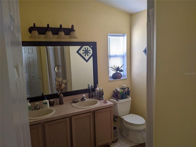 bathroom with vanity, toilet, and tile patterned floors