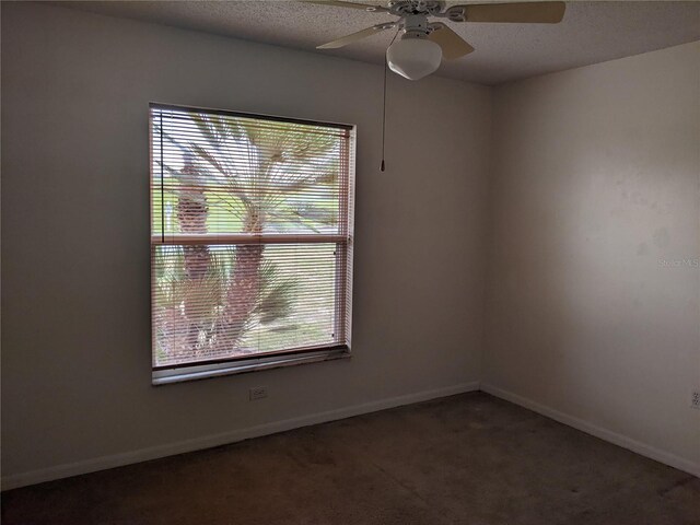 carpeted empty room featuring a textured ceiling, a healthy amount of sunlight, and ceiling fan