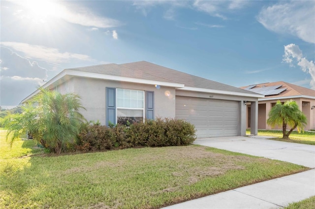 single story home with solar panels, a garage, and a front yard