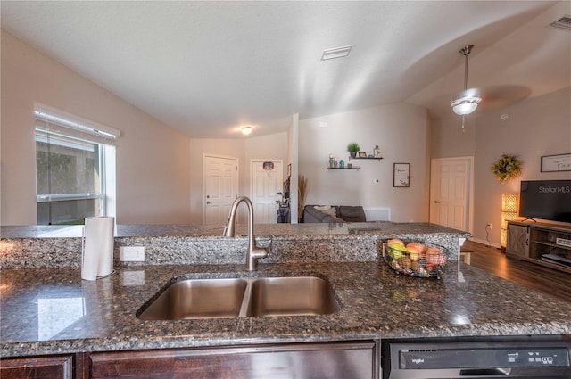 kitchen featuring ceiling fan, hardwood / wood-style flooring, dark stone countertops, and lofted ceiling