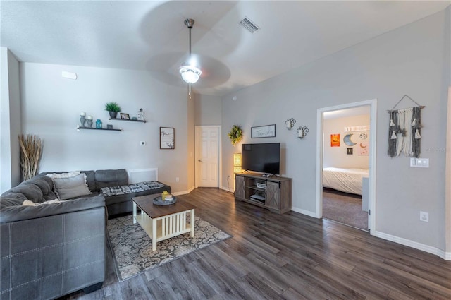 carpeted living room featuring ceiling fan and vaulted ceiling