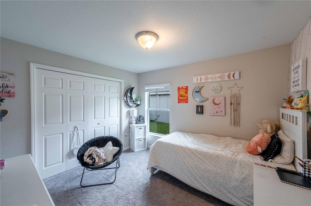 carpeted bedroom featuring a closet and a textured ceiling