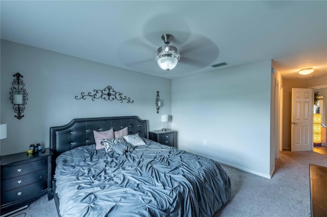 carpeted bedroom featuring baseboards, visible vents, and a ceiling fan