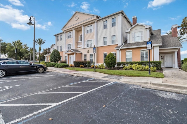 view of vehicle parking with a garage and a lawn