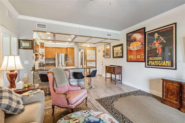 living room with light hardwood / wood-style floors and crown molding